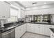 Updated kitchen with stainless steel appliances, granite countertops, and plentiful cabinet space at 7715 Radcliffe Cir, Port Richey, FL 34668