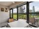 Sunroom area featuring tile flooring, views of backyard, and dining set at 7715 Radcliffe Cir, Port Richey, FL 34668