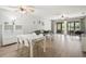 Spacious living room featuring wood-look floors, a modern ceiling fan, and sliding glass doors to the patio at 7715 Radcliffe Cir, Port Richey, FL 34668