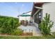 Spacious backyard patio with garden landscaping and outdoor dining set for entertainment at 7715 Radcliffe Cir, Port Richey, FL 34668