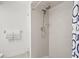 Shower with updated shower head and white tile at 7715 Radcliffe Cir, Port Richey, FL 34668