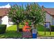 Landscaped walkway with blooming trees, leading to community buildings at 7715 Radcliffe Cir, Port Richey, FL 34668