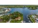 Beautiful aerial showcasing a waterfront home with private boat dock access to a calm, scenic river at 8143 Channel Dr, Port Richey, FL 34668