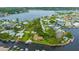 Panoramic aerial showcases a waterfront home's private boat dock and serene river, surrounded by lush landscaping at 8143 Channel Dr, Port Richey, FL 34668