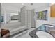Bright bathroom featuring a large soaking tub, dual sinks, and unique glass block accents at 8143 Channel Dr, Port Richey, FL 34668