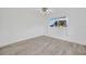 Bright bedroom featuring wood-look floors, a ceiling fan, and a window view at 8143 Channel Dr, Port Richey, FL 34668