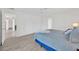 Bedroom with light hardwood floors, ceiling fan, and access to other rooms at 8143 Channel Dr, Port Richey, FL 34668