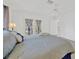 Bedroom with light hardwood floors, ceiling fan, and access to the balcony at 8143 Channel Dr, Port Richey, FL 34668