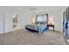 Bedroom with light hardwood floors, ceiling fan, and ensuite bathroom at 8143 Channel Dr, Port Richey, FL 34668