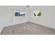 Bright bedroom featuring modern flooring and backyard views at 8143 Channel Dr, Port Richey, FL 34668