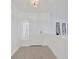 Bright foyer features a tiled floor, a front door with lace curtains, and windows with patterned curtains at 8143 Channel Dr, Port Richey, FL 34668
