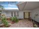 Home featuring a well-manicured landscape, a brick-paved walkway, and a covered front porch at 8143 Channel Dr, Port Richey, FL 34668