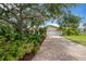 Charming home boasts a well-maintained brick driveway, lush landscaping, and a two-car garage at 8143 Channel Dr, Port Richey, FL 34668