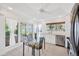 Bright kitchen featuring white cabinets, stainless steel appliances, and view to the outside at 8143 Channel Dr, Port Richey, FL 34668