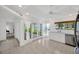 Bright kitchen with white cabinets, stainless steel appliances, and view to the outside at 8143 Channel Dr, Port Richey, FL 34668