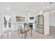 Bright kitchen featuring white cabinets, stainless steel appliances, and a glass dining table at 8143 Channel Dr, Port Richey, FL 34668