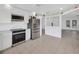 Bright kitchen with stainless steel appliances and open view to the adjacent living area at 8143 Channel Dr, Port Richey, FL 34668