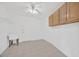 Clean laundry room with tile floors, utility sink, and ample cabinet storage at 8143 Channel Dr, Port Richey, FL 34668