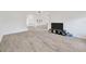 Spacious living room with wood-look floors, and media console at 8143 Channel Dr, Port Richey, FL 34668