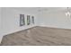 Bright living room featuring wood-look floors and decorative windows at 8143 Channel Dr, Port Richey, FL 34668
