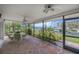 Enclosed patio featuring stone floors and views of tropical waterway at 8143 Channel Dr, Port Richey, FL 34668