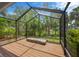 Enclosed patio showcasing wood floors and views of the backyard at 8143 Channel Dr, Port Richey, FL 34668