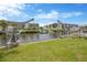 Waterfront scene showing grassy banks, docking facilities and views of nearby condos at 8143 Channel Dr, Port Richey, FL 34668