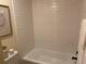 Bright bathroom featuring white subway tile, a bathtub, and modern fixtures at 8209 Golf Club Ct, Hudson, FL 34667