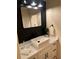 Modern bathroom features a white vessel sink, black fixtures, and dark shiplap accent wall at 8209 Golf Club Ct, Hudson, FL 34667