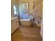 Luxurious bathroom features a soaking tub, modern fixtures, and elegant tile work at 8209 Golf Club Ct, Hudson, FL 34667