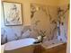 Luxurious bathroom featuring a soaking tub, patterned tile, and modern fixtures at 8209 Golf Club Ct, Hudson, FL 34667