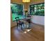 Charming dining area with a view of the lush greenery outside the window at 8209 Golf Club Ct, Hudson, FL 34667