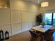 Inviting dining room with paneling, natural light, and a modern chandelier at 8209 Golf Club Ct, Hudson, FL 34667