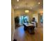 Dining room with a modern farmhouse table, wicker chairs, recessed lighting, and stylish wall paneling at 8209 Golf Club Ct, Hudson, FL 34667
