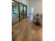 Open hallway with wood floors leading to living room, sunroom, and bedroom at 8209 Golf Club Ct, Hudson, FL 34667