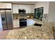 Modern kitchen features granite countertops, stainless steel appliances and ample cabinet space at 8209 Golf Club Ct, Hudson, FL 34667