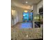Modern kitchen with white cabinets, granite countertops, stainless steel appliances, and eating area at 8209 Golf Club Ct, Hudson, FL 34667