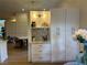 Kitchen storage with granite countertops, and upper cabinets with gold hardware and recessed lighting at 8209 Golf Club Ct, Hudson, FL 34667
