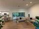 Open concept living room with views of kitchen, and floor-to-ceiling sliding glass doors leading to outdoors at 8209 Golf Club Ct, Hudson, FL 34667