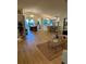 Spacious open-concept living space with kitchen, dining area, and living room, all with hardwood floors at 8209 Golf Club Ct, Hudson, FL 34667
