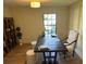 Bright home office features hardwood floors, a large desk, and a window with natural light at 8209 Golf Club Ct, Hudson, FL 34667