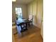 Bright office space with dark wood desk, paneled walls and natural light at 8209 Golf Club Ct, Hudson, FL 34667