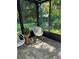 Cozy sunroom with brick floors, comfortable seating, and lush views of greenery at 8209 Golf Club Ct, Hudson, FL 34667