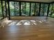 Enclosed sunroom with wall-to-wall windows provides views of the outdoor landscape at 8209 Golf Club Ct, Hudson, FL 34667