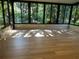 Spacious sunroom with wood-look floors and large windows offering ample natural light at 8209 Golf Club Ct, Hudson, FL 34667