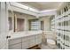 Bright bathroom featuring a skylight, vanity, and shower-tub combo for relaxation at 8540 Caitlin Ct, Hudson, FL 34667