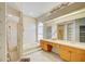 Bright bathroom featuring a tub, shower, dual sinks and a large mirror at 8540 Caitlin Ct, Hudson, FL 34667