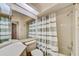 Cozy bathroom featuring a shower-tub combo, complemented by a neutral-toned shower curtain at 8540 Caitlin Ct, Hudson, FL 34667