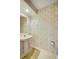 Bathroom with pedestal sink, floral wallpaper, and tile floor at 8540 Caitlin Ct, Hudson, FL 34667
