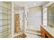 Bathroom with a separate tub, glass shower and glass shelving at 8540 Caitlin Ct, Hudson, FL 34667